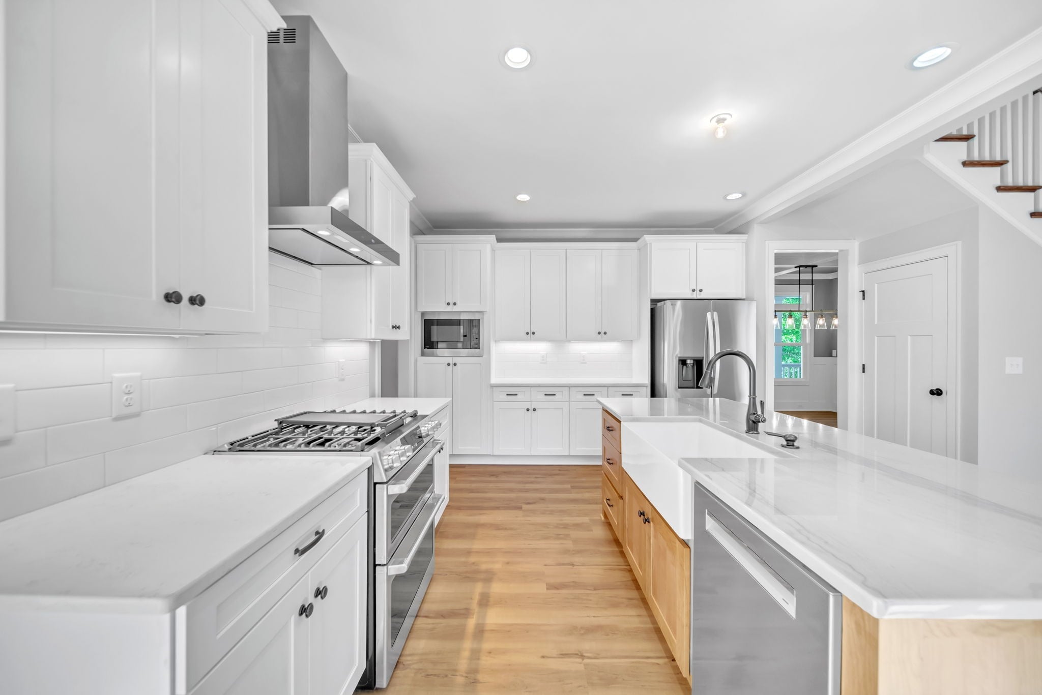 Kitchen with double-oven range, stainless hood and farmhouse sink