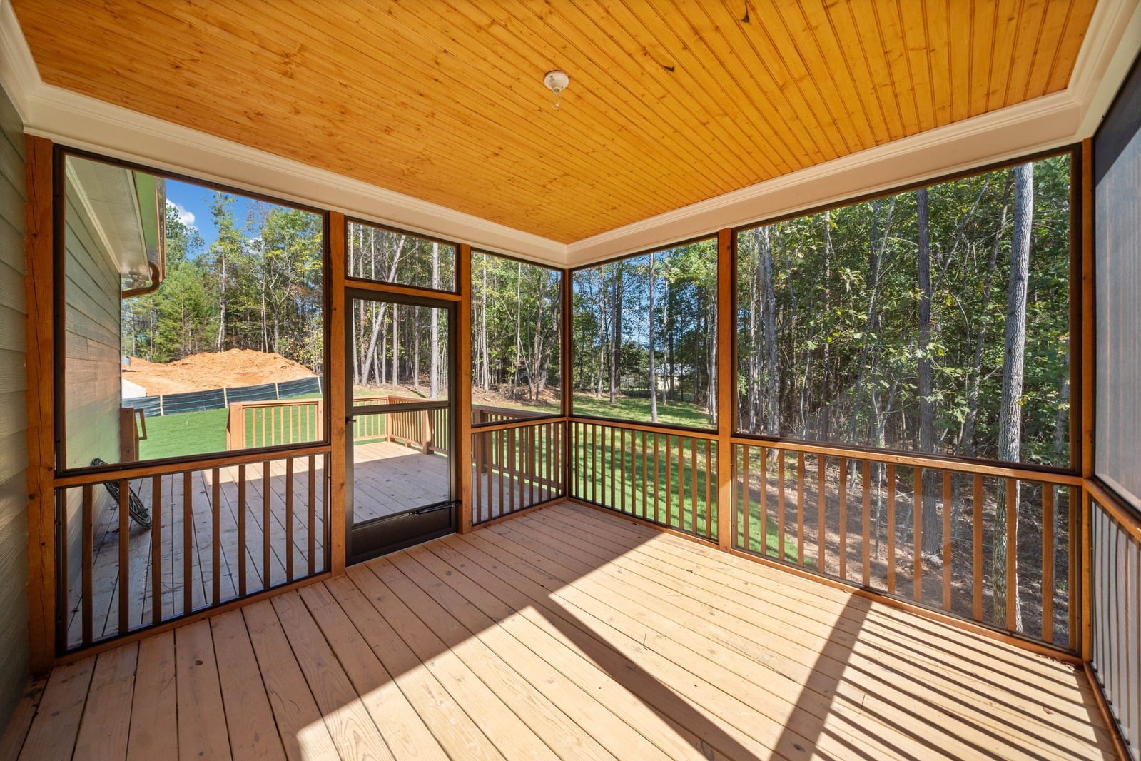 Screened back porch with pine ceiling overlooking woods