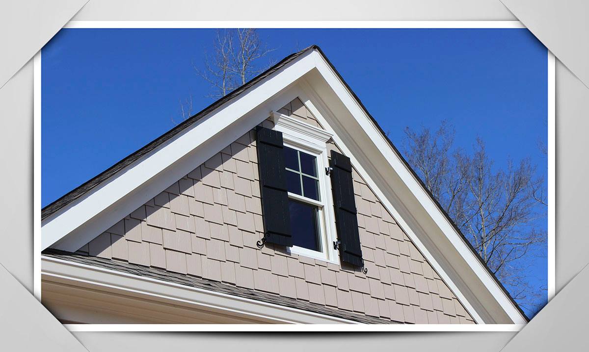 gable detail with shingles and black shutters and white trim
